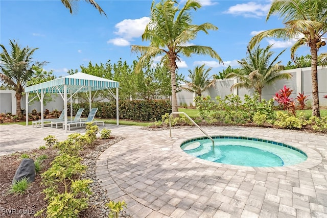 view of swimming pool with an in ground hot tub and a patio area