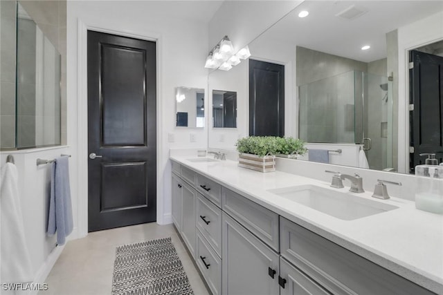 bathroom featuring walk in shower, tile patterned floors, and vanity