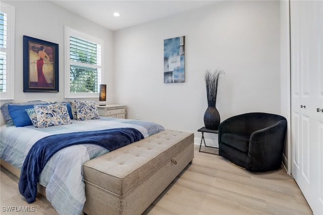 bedroom featuring light hardwood / wood-style floors and a closet