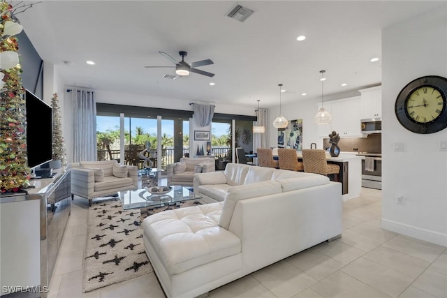 living room featuring ceiling fan and light tile patterned floors