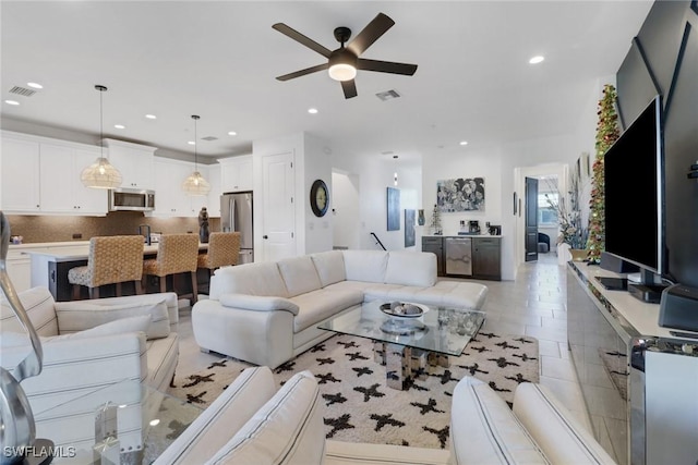 tiled living room with ceiling fan