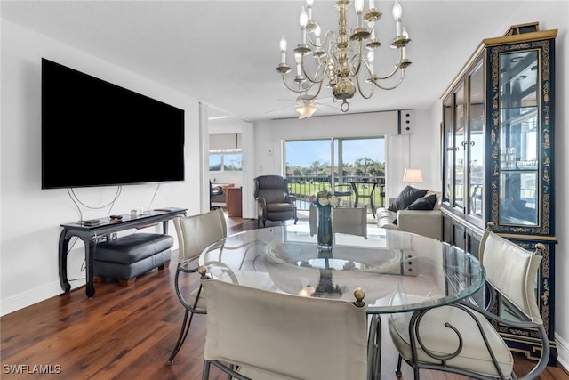 dining area featuring baseboards, an inviting chandelier, and wood finished floors