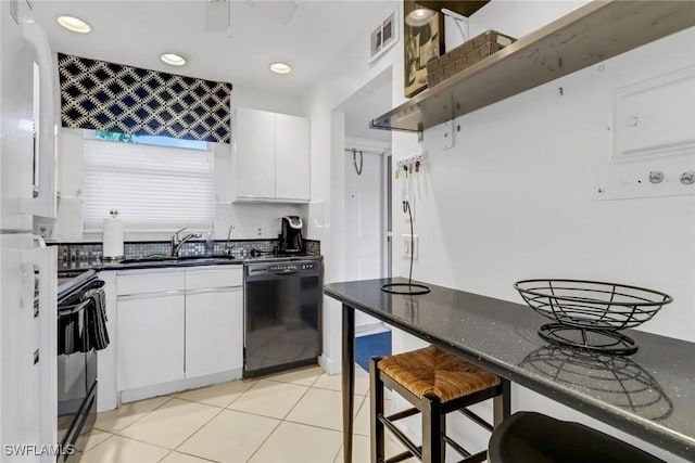 kitchen with black appliances, light tile patterned floors, white cabinetry, a ceiling fan, and a sink