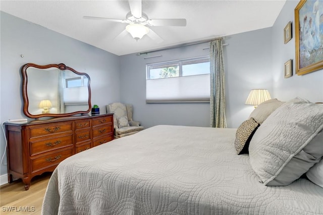 bedroom with light wood-style flooring and ceiling fan