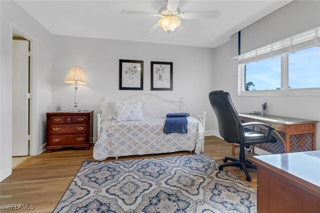 home office featuring light wood-style flooring, baseboards, and ceiling fan