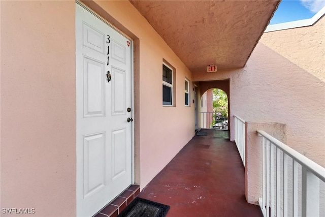 entrance to property featuring stucco siding