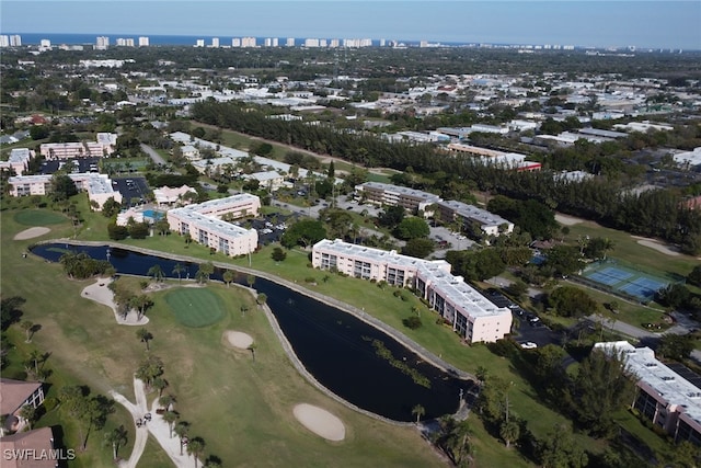 birds eye view of property featuring a view of city, view of golf course, and a water view