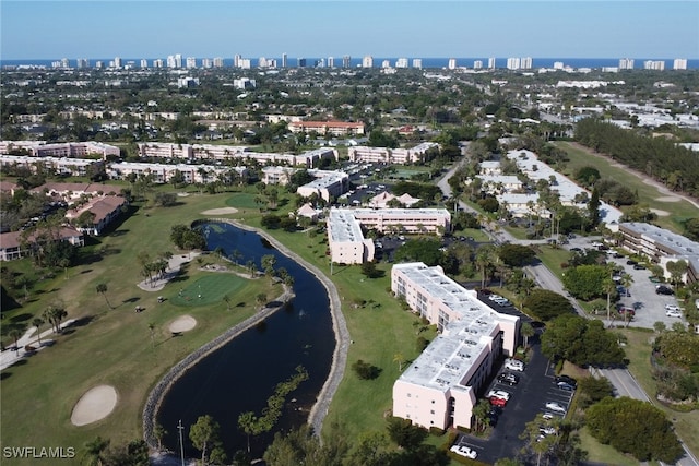 birds eye view of property with a view of city and a water view