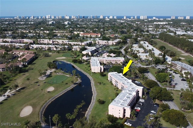 drone / aerial view with a city view and a water view