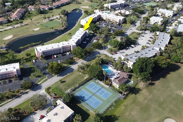 birds eye view of property featuring view of golf course and a water view