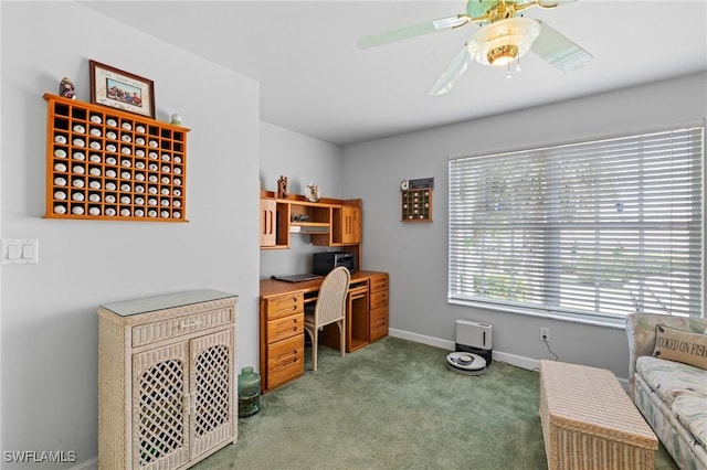 carpeted home office with ceiling fan