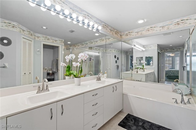 bathroom featuring tile patterned floors, independent shower and bath, and vanity