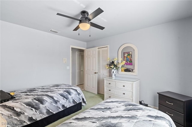 carpeted bedroom with a closet and ceiling fan