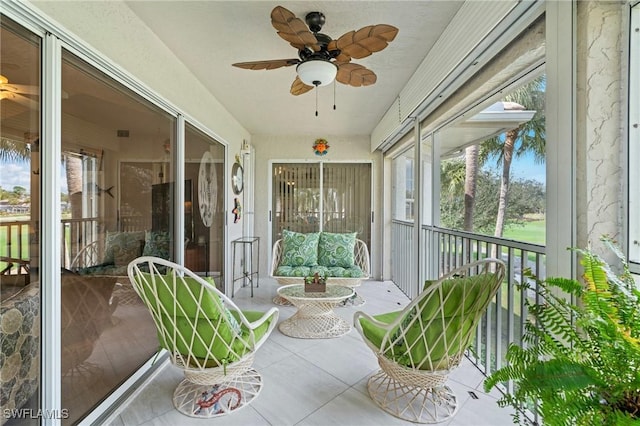 sunroom / solarium featuring ceiling fan