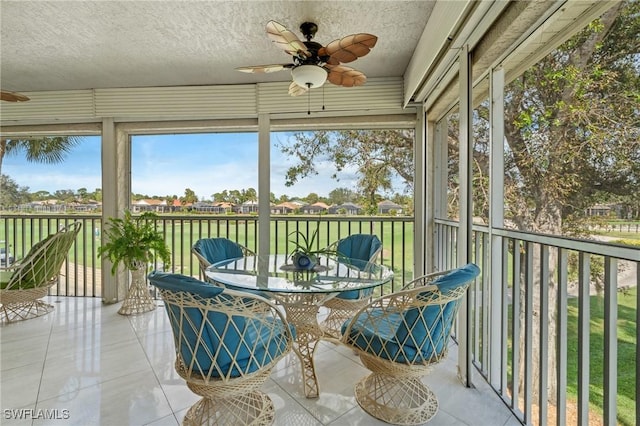 sunroom / solarium featuring ceiling fan