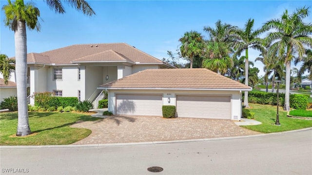 view of front of property featuring a front lawn and a garage