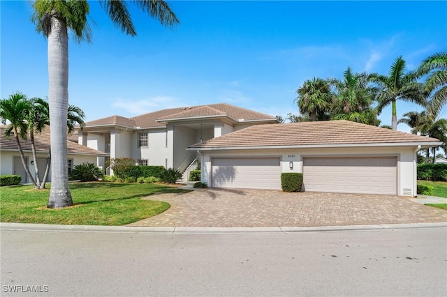 view of front of home featuring a garage and a front lawn