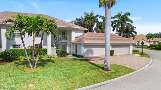 view of front of home featuring a garage and a front lawn