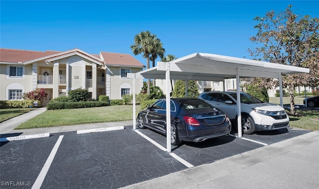 view of parking / parking lot with a lawn and a carport