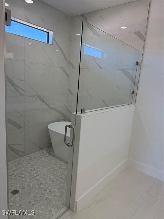 bathroom with separate shower and tub