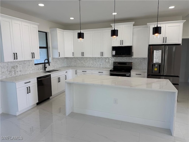 kitchen featuring white cabinetry, a center island, decorative light fixtures, and black appliances