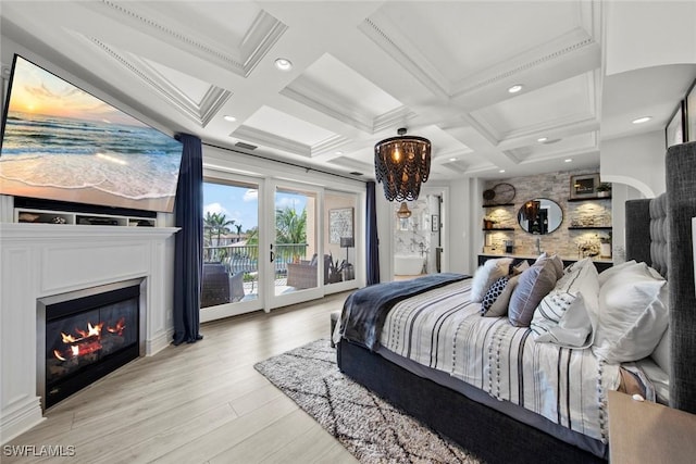 bedroom featuring coffered ceiling, light hardwood / wood-style floors, beam ceiling, and access to outside