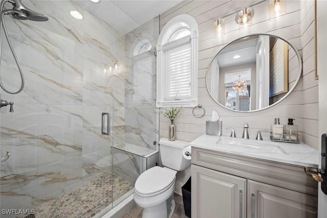 bathroom featuring walk in shower, vanity, toilet, and backsplash