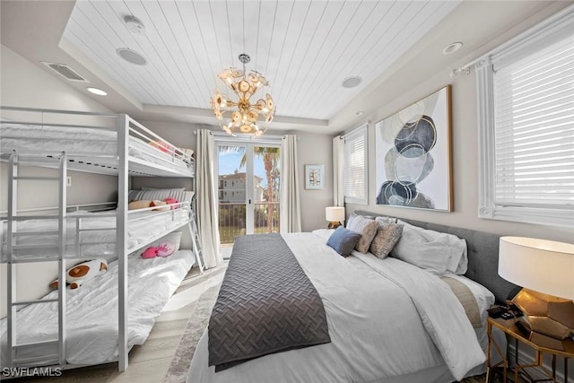 bedroom featuring access to outside, a notable chandelier, a raised ceiling, wooden ceiling, and light hardwood / wood-style flooring