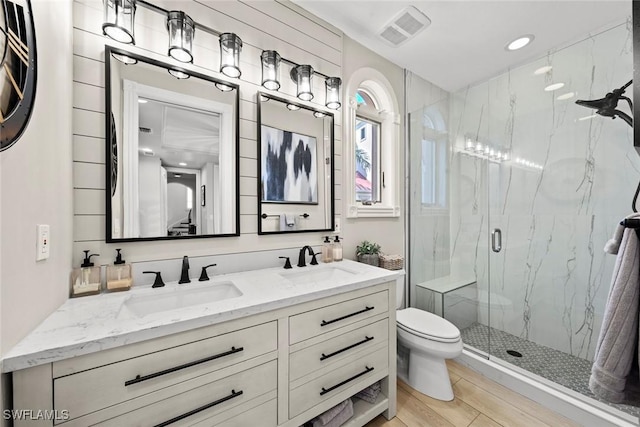 bathroom with vanity, wood-type flooring, an enclosed shower, and toilet