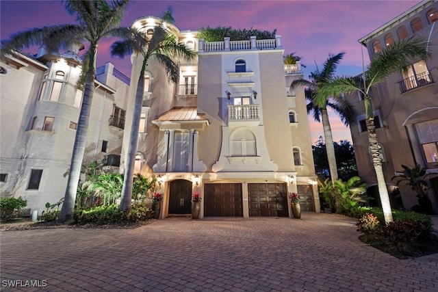 5332 Barefoot Bay Ct, Bonita Springs, FL 34134 - outdoor building at dusk with a garage