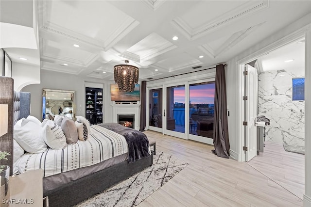 bedroom featuring beamed ceiling, coffered ceiling, access to exterior, and light hardwood / wood-style flooring