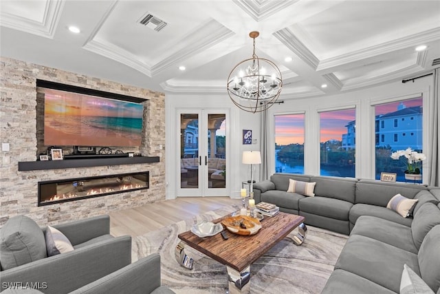 living room featuring a stone fireplace, beamed ceiling, coffered ceiling, light hardwood / wood-style floors, and french doors