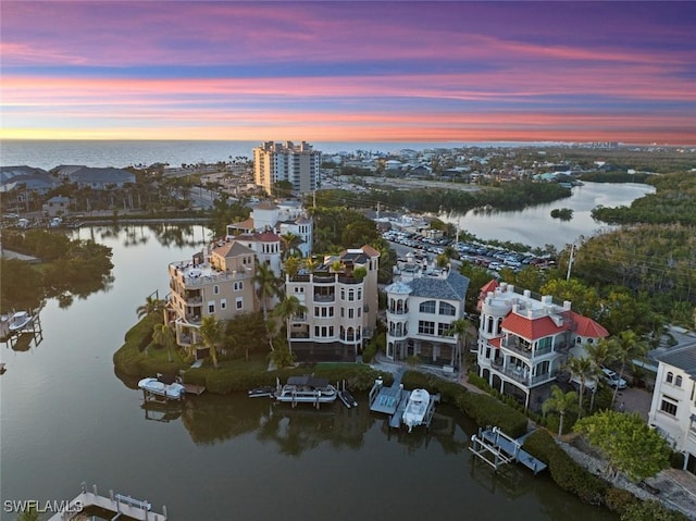 aerial view at dusk with a water view