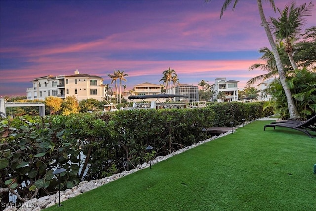 view of home's community featuring a lawn