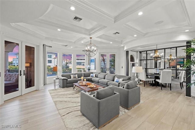 living room featuring french doors, coffered ceiling, light wood-type flooring, ornamental molding, and a notable chandelier