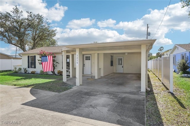 single story home featuring a front yard and a carport