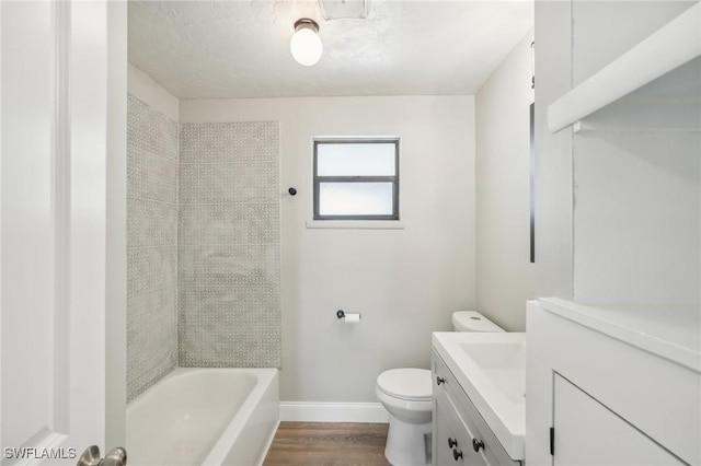 full bathroom with vanity, tiled shower / bath combo, wood-type flooring, and toilet