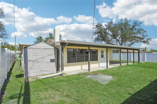 back of property featuring a storage shed, a yard, and a patio area