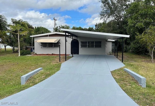 view of front facade with a front lawn and a carport