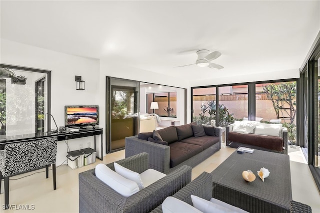 living room featuring a wealth of natural light and ceiling fan