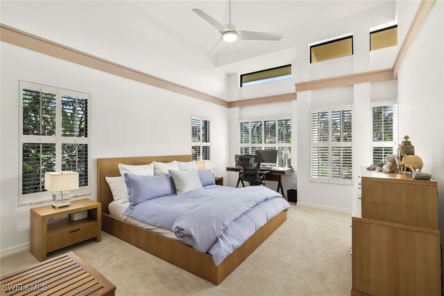 bedroom with lofted ceiling, light colored carpet, and ceiling fan