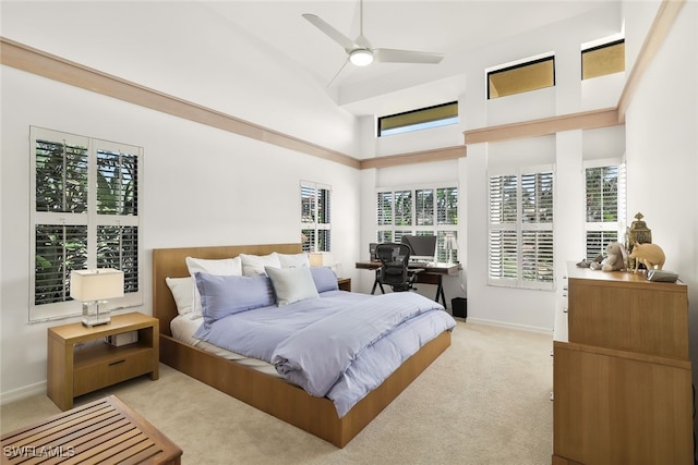 bedroom featuring light colored carpet, ceiling fan, and baseboards