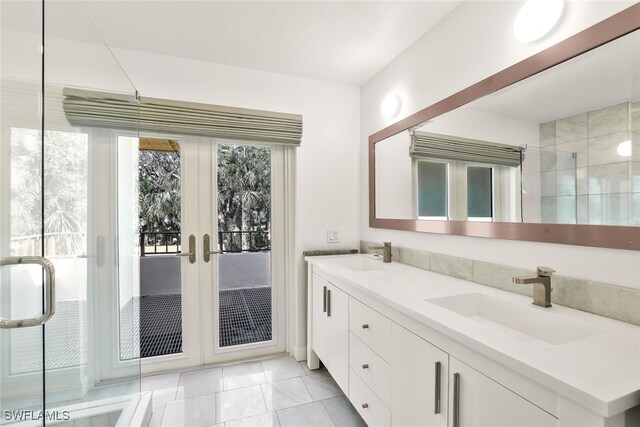 bathroom with french doors, tile patterned floors, vanity, and a shower with shower door