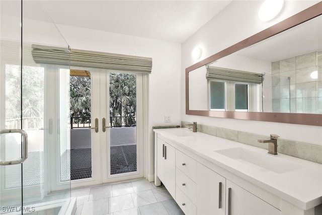 full bathroom with tile patterned floors, french doors, a sink, and double vanity