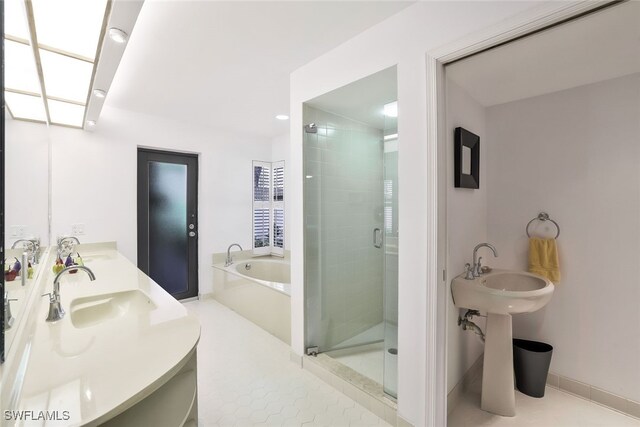 bathroom with tile patterned floors and independent shower and bath