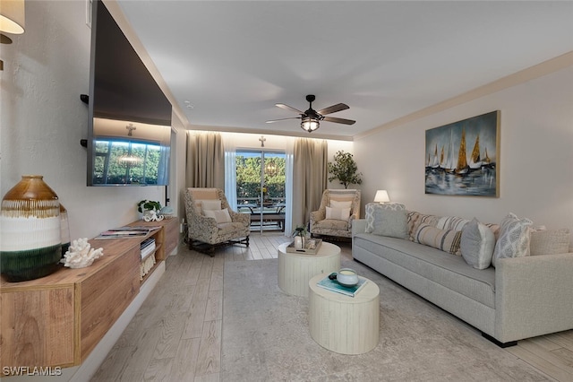 living room with ceiling fan and light wood-type flooring