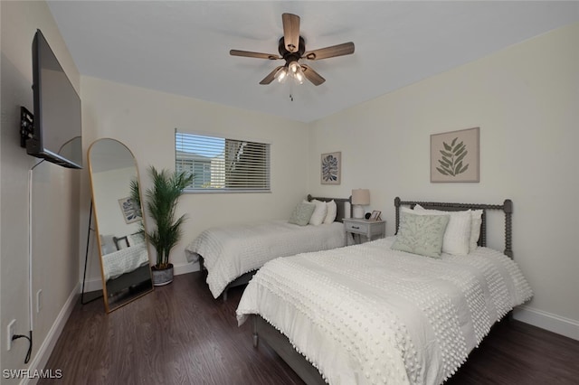 bedroom with dark hardwood / wood-style floors and ceiling fan