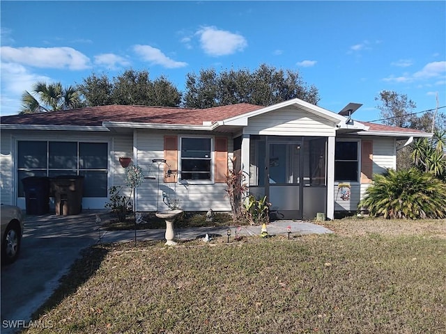 view of front facade featuring a sunroom and a front lawn