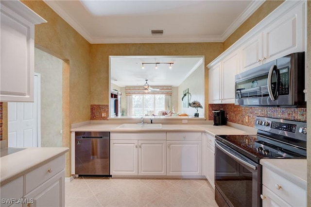 kitchen with sink, crown molding, appliances with stainless steel finishes, white cabinets, and backsplash