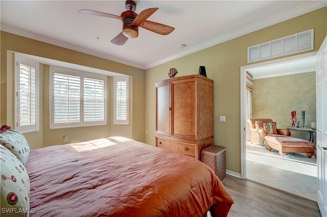 bedroom featuring ornamental molding, ceiling fan, and light wood-type flooring